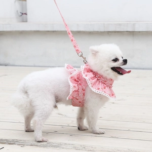 Detailed view of pink floral pet harness with white lace trim and metal swivel hook