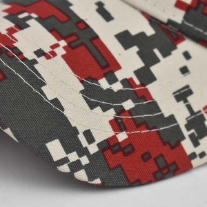 Detailed macro view of digital camouflage fabric with red and grey pixels and durable stitching