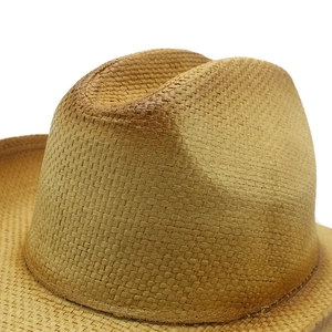 Close-up of the detailed hand-woven texture on this light brown western straw cowboy hat