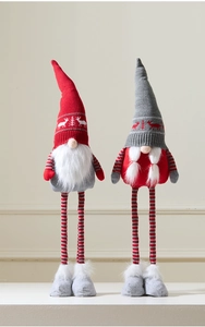 Detail of Christmas gnomes with knitted deer patterns and fluffy grey boots for holiday decor
