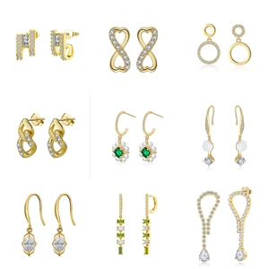 Collection of nine S925 gold-plated earrings featuring zircon and green gemstone details