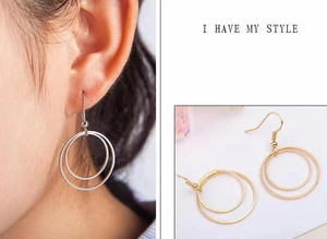 Detailed view of minimalist double-layered hoop earrings in gold and silver finish