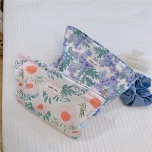 Detailed macro view of floral cotton makeup bags with high-quality metal zipper closure
