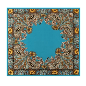 Detailed pattern of teal square silk scarf featuring intricate brown paisley and floral prints