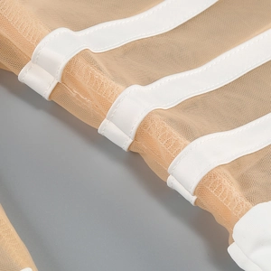 Detail of mesh paneling and white structural stitching on a slim bodycon dress