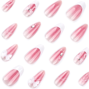 Pink cat eye gradient press-on nails with white French tips and 3D bow accents
