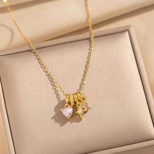 18k gold plated heart pendant necklace with pink zircon and star charm on jewelry box