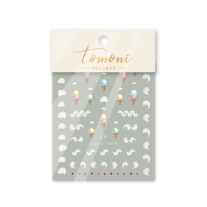 Detail view of embossed nail art stickers featuring strawberry ice cream and red dot designs