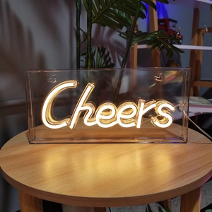 Detailed close-up of Cheers LED neon sign in acrylic box with warm white lighting