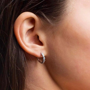 Close-up of S925 sterling silver turquoise earring worn on ear showing fine details