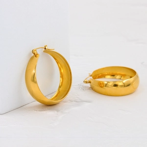 Modern gold wide band chunky hoop earrings with a polished metallic finish for women