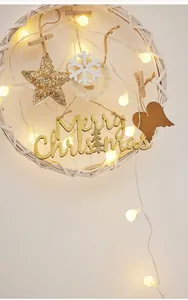 Detail of woven Christmas wreath with LED lights, snowflakes, and Merry Christmas sign