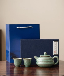 Detail of Ru kiln ice crackle celadon ceramic teapot and cups with luxury blue gift box