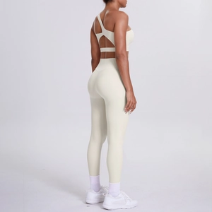 Detail view of cream yoga set showing criss-cross back sports bra and high waist leggings