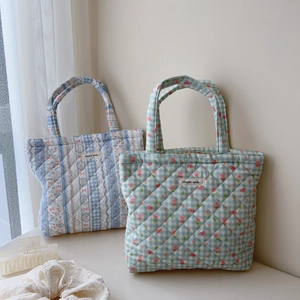 Quilted floral and grid cotton tote bags with simple wish label on soft fabric