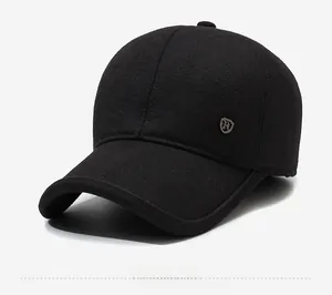 Detail view of the black wool texture and metal R-logo on the ear-flap baseball cap