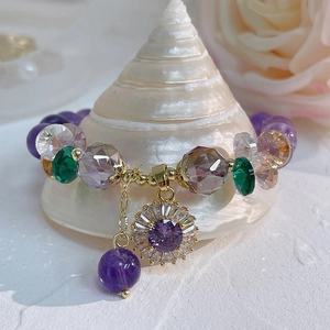 Natural amethyst flower bracelet with pavé cubic zirconia and gold beads on a seashell