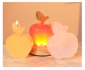 Detailed apple-shaped silicone mold for DIY fruit candles and resin lamps on marble surface