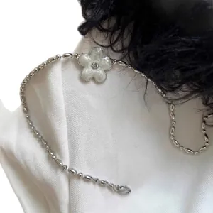 Silver beaded necklace with white flower pendant and sparkling crystal center