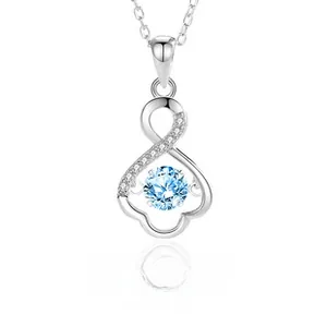 Detail of S925 sterling silver infinity heart pendant with a dancing blue gemstone