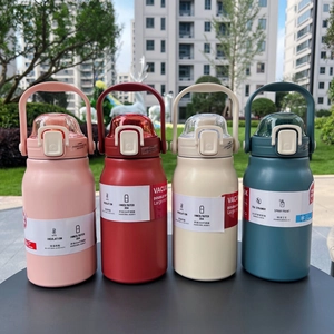 Detail of four colorful 304 stainless steel vacuum flasks on outdoor table