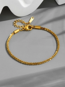 Detailed close-up of gold-plated stainless steel bracelet with adjustable lobster clasp