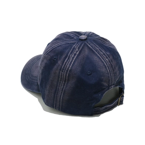 Detail of washed navy cotton baseball cap showing adjustable metal buckle and stitching