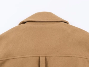 Close-up of the collar and shoulder seams of a camel wool blend coat with neat stitching