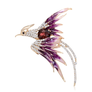 Elegant gold phoenix brooch with purple enamel wings and sparkling crystal rhinestones