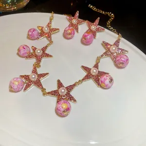 Pink star jewelry set featuring stone earrings and necklace with marble beads