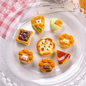 Detailed view of miniature resin food charms including pizza and croissants for DIY crafts