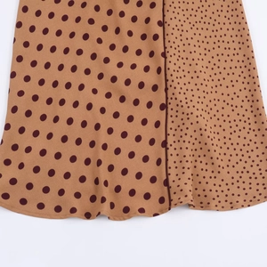 Brown polka dot midi dress featuring a mix of large and small patterns on lightweight fabric