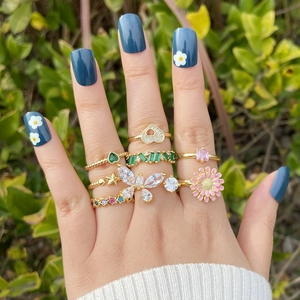 Gold daisy butterfly heart ring set with colorful zircon stones on model hand