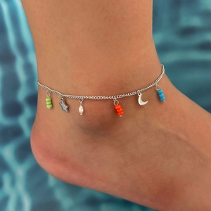 Silver stainless steel anklet with colorful star and moon charms on model's ankle