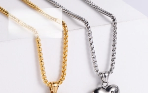 Detailed close-up of 3D heart pendants in gold and silver finish with box chains