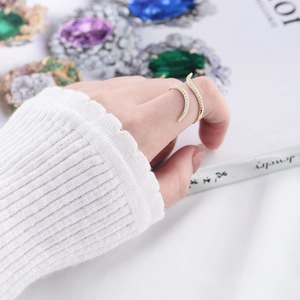 Close-up of gold adjustable open ring with pavé micro zircons on a model's hand