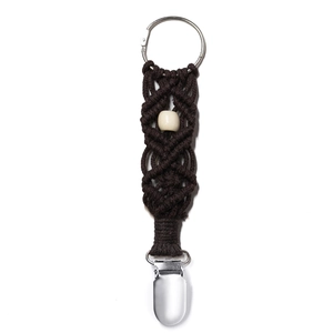 Detailed close-up of dark brown hand-woven strap with wooden bead and sturdy metal clip