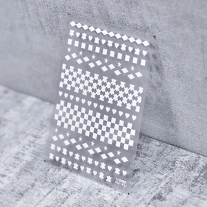 Macro detail of to 2485 nail stickers showing checkers, hearts, and stars pattern