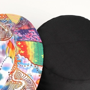 Double-sided reversible bucket hat with colorful abstract print and black twill fabric