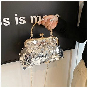 Detail of silver sequin evening clutch bag with gold vintage frame and ornate handle