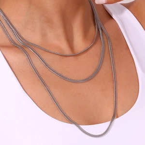 Three-layer silver stainless steel foxtail necklace set shown on a female model