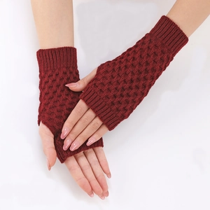 Detail of red cable knit fingerless gloves showing the honeycomb crochet pattern
