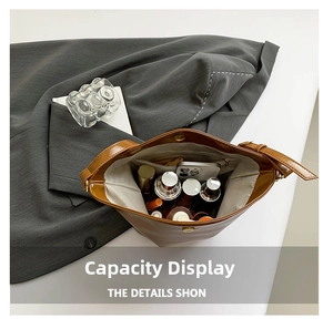 Detail view of large capacity brown bucket bag with inner pockets and zip compartment