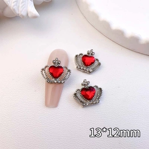 Macro detail of crown nail art charm with red heart gem and rhinestone, size 13x12mm
