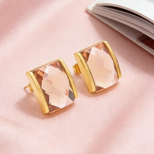 Macro shot of elegant 18K gold plated earrings with rectangular pink crystal stones