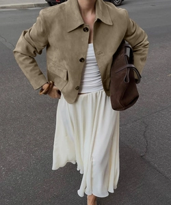 Detailed close-up of khaki faux suede jacket with buttons and casual urban street style