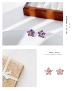 Detail view of dainty floral stud earrings with purple and pink zircon petals