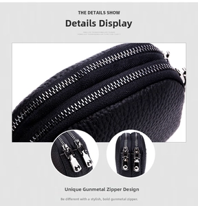 Detail of double gunmetal zippers on black pebble leather coin purse compartments