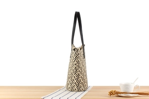 Detail of herringbone weave pattern in black and beige with durable black leather handle