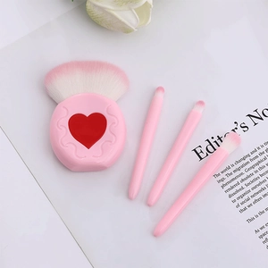 Detail view of pink heart-shaped makeup brush set including 4 pieces for travel